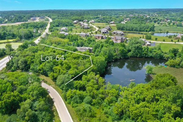 an aerial view of residential houses with outdoor space and swimming pool