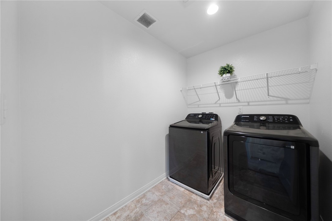 20130 Curaco Court Riverside, CA 92507 - Photo 29 of 43 Separate laundry room with washer, dryer, and overhead shelving.