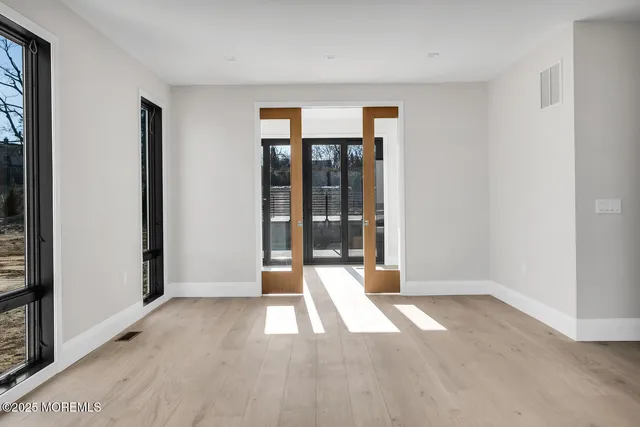 an empty room with windows and closet