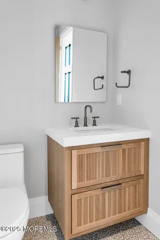 a bathroom with a toilet a sink and a window