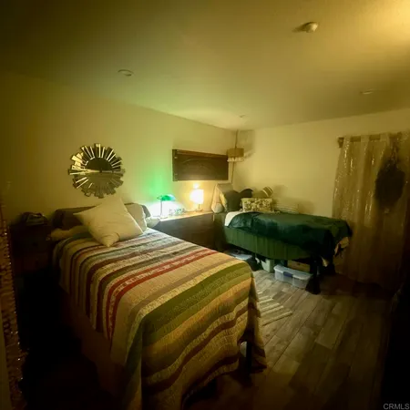 a bedroom with bed and a chandelier