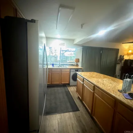 a kitchen with a sink and wooden cabinets