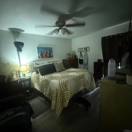 a bedroom with a bed and a mirror