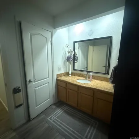 a bathroom with a double vanity sink and mirror