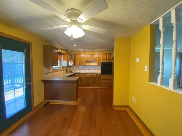 a view of kitchen with cabinets and wooden floor