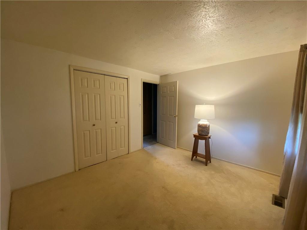 744 North Gross Street Conway, PA 15027 - Photo 13 of 29 a room that has a bed and a chair in it