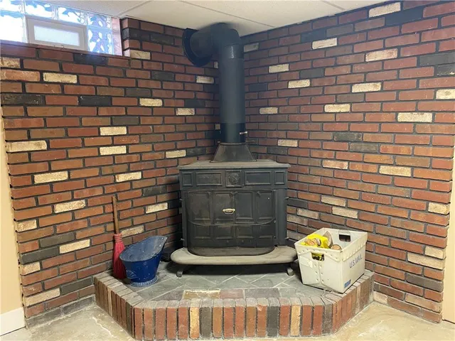 a view of a house with a large tree and a yard
