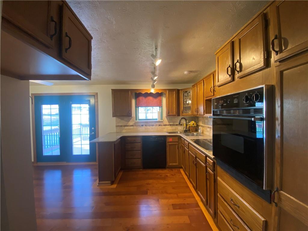 744 North Gross Street Conway, PA 15027 - Photo 5 of 29 a kitchen with granite countertop a refrigerator stove and wooden floor