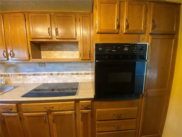 a kitchen with a refrigerator and cabinets