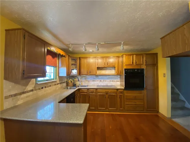 a kitchen with a sink and large window