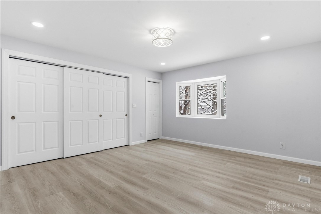 3190 Rebert Pike Springfield, OH 45502 - Photo 48 of 48 This bright and airy primary bedroom features ample natural light and modern flooring, creating a versatile living space.