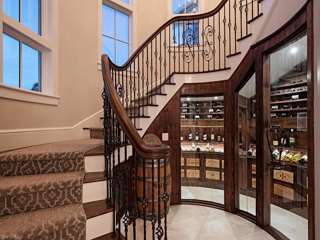 2615 Tarpon Road Naples, FL 34102 - Photo 11 of 20 a view of staircase with lots of frames on wall and a window