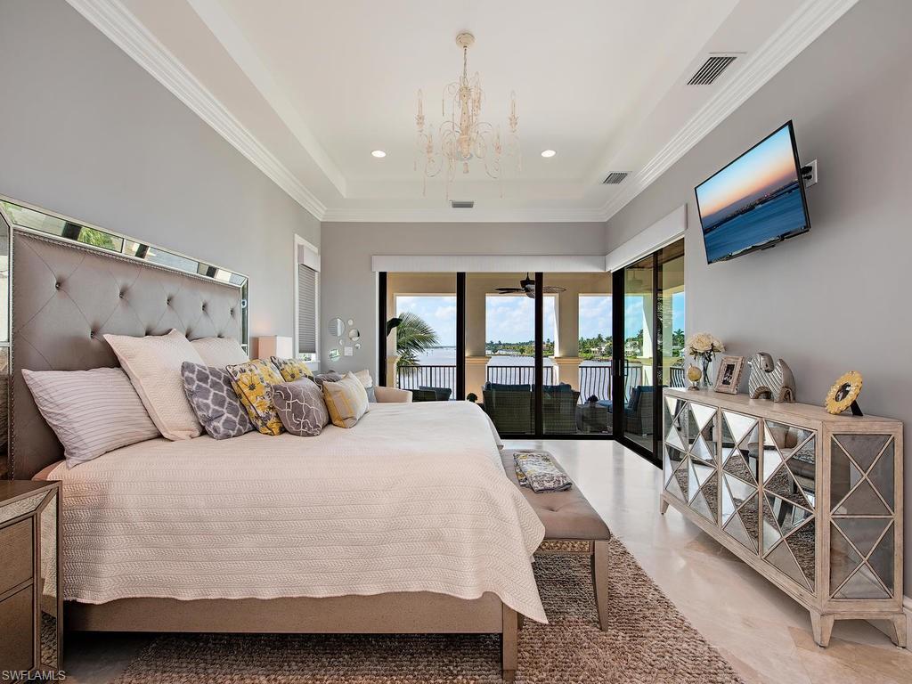 2615 Tarpon Road Naples, FL 34102 - Photo 15 of 20 a large bed sitting in a bedroom next to a window