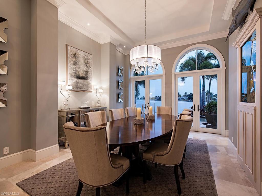 2615 Tarpon Road Naples, FL 34102 - Photo 6 of 20 a view of a dining room with furniture wooden floor and chandelier