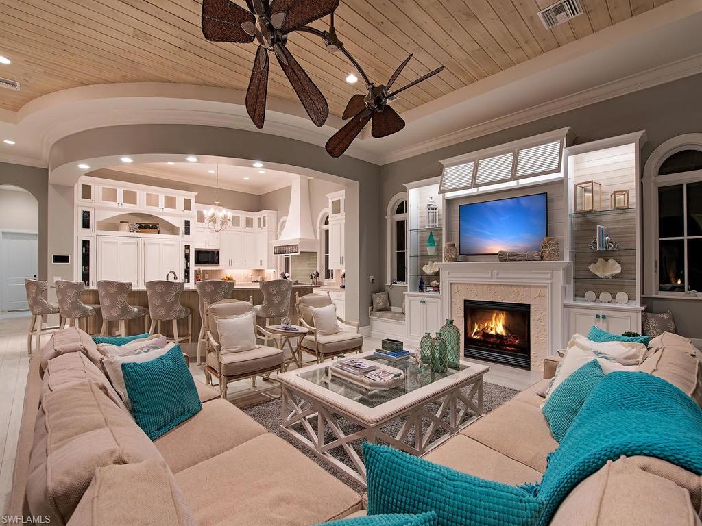 2615 Tarpon Road Naples, FL 34102 - Photo 9 of 20 a living room with furniture a fireplace and a flat screen tv