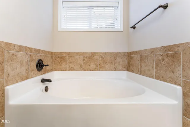 a view of walk in closet with clothes