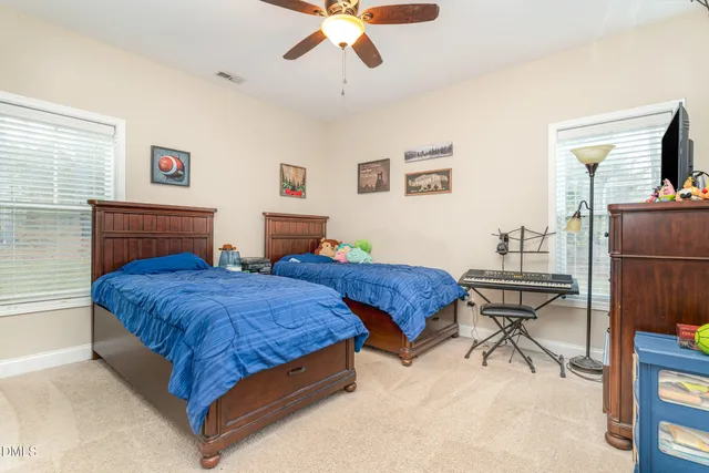 a view of a bedroom with baby crib and toys