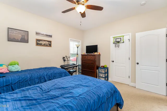 a dining room with furniture and chandelier fan