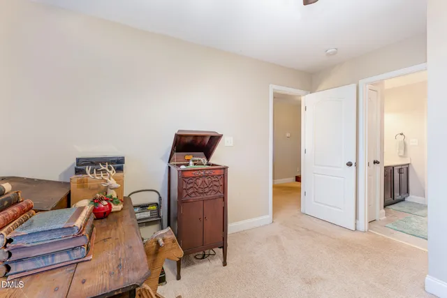 a living room with furniture and a book shelf