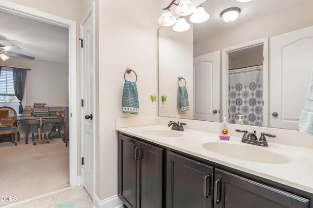 a bathroom with a sink toilet and mirror