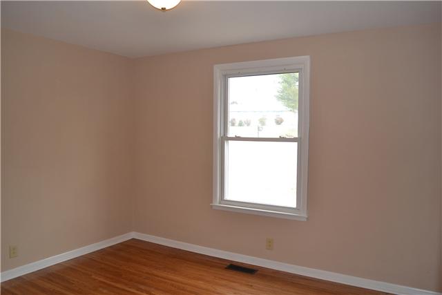 106 Chiroc Road Hendersonville, TN 37075 - Photo 14 of 20 The Third bedroom has a window that enjoys views of the pretty front yard, hardwood floor, and new light fixture. Just outside this room in the hallway is a convenient linen/storage closet.