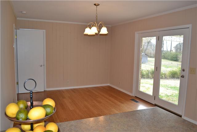 This comfortable Den is open to the Kitchen area & enjoys a dble, clear view glass French Door that provides sweeping views of the huge backyard!