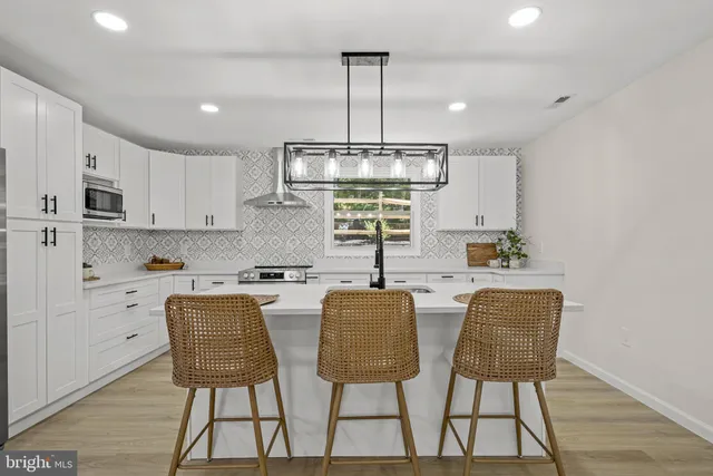 a kitchen with a sink cabinets and wooden floor