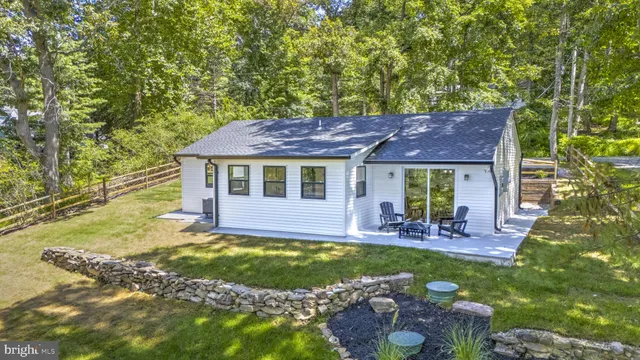 a view of house with swimming pool outdoor seating and yard