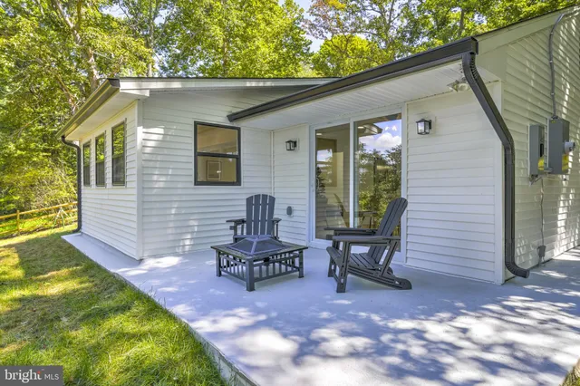 a view of house with swimming pool outdoor seating and yard
