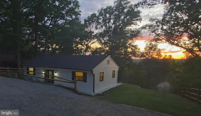a view of backyard with wooden fence