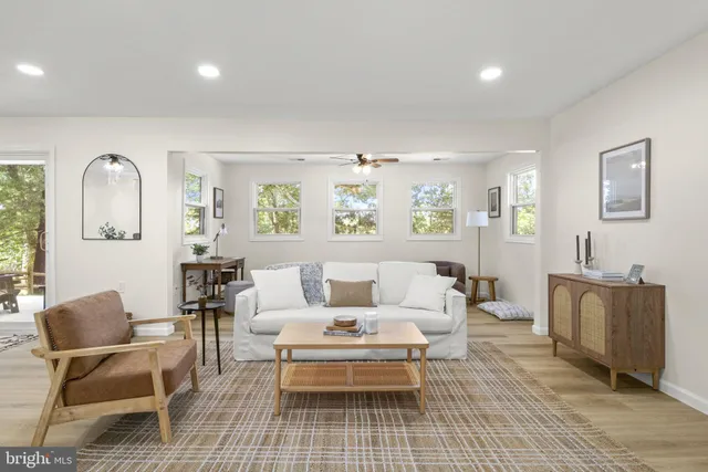 a living room with furniture and wooden floor