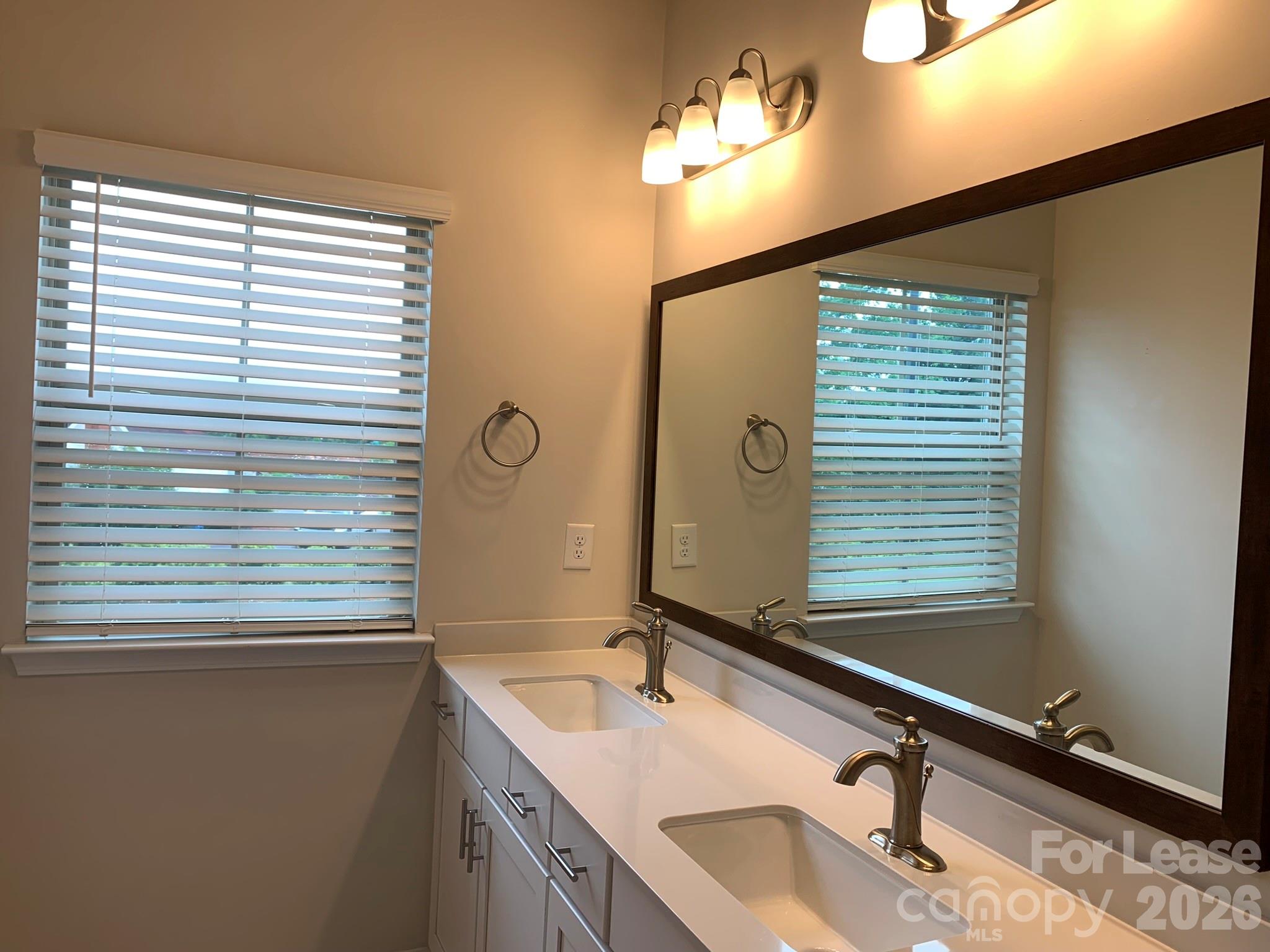 2143 Stevens Mill Road Matthews, NC 28104 - Photo 21 of 39 a bathroom with a sink and a mirror