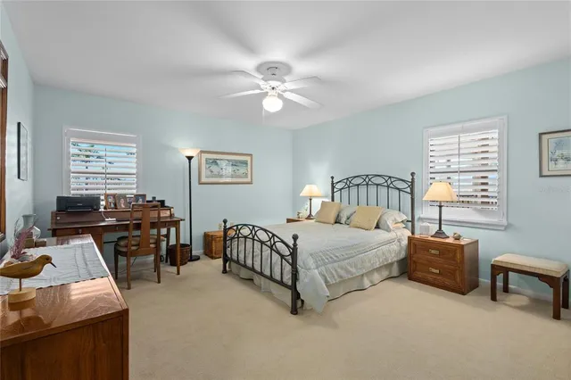 a bedroom with a large bed and a chandelier