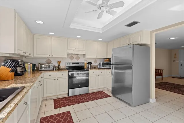 a kitchen with granite countertop a sink stainless steel appliances and cabinets