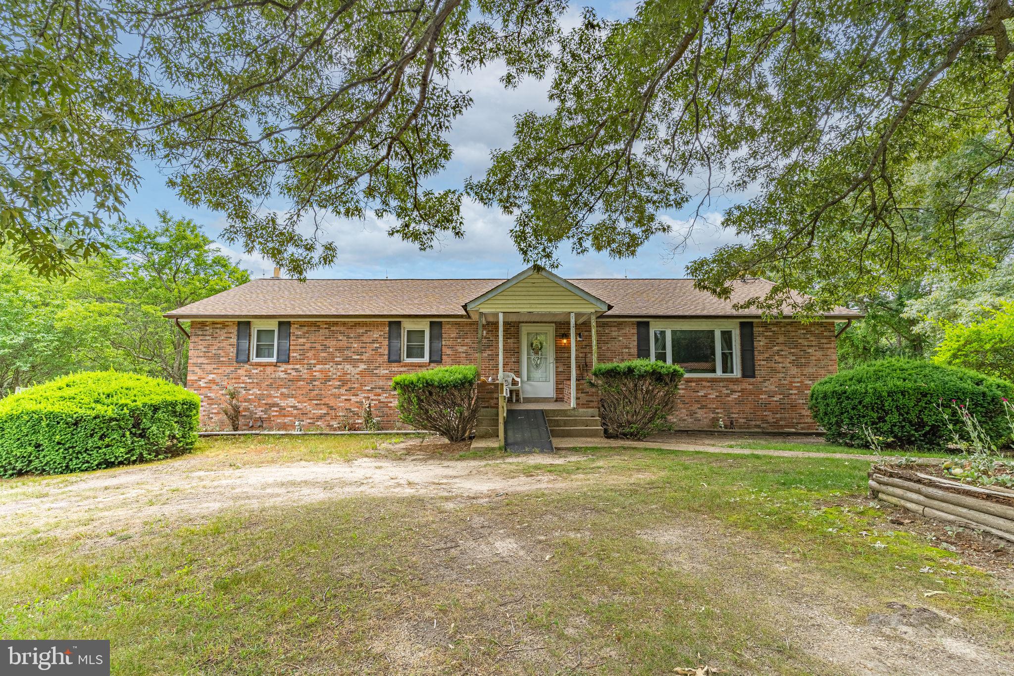 5865 Mackall Road St. Leonard, MD 20685 - Photo 2 of 24 a front view of a house with yard