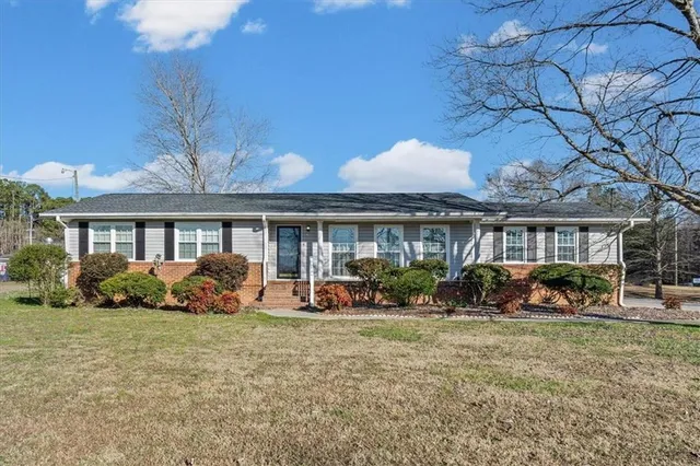 a front view of a house with sitting space and garden
