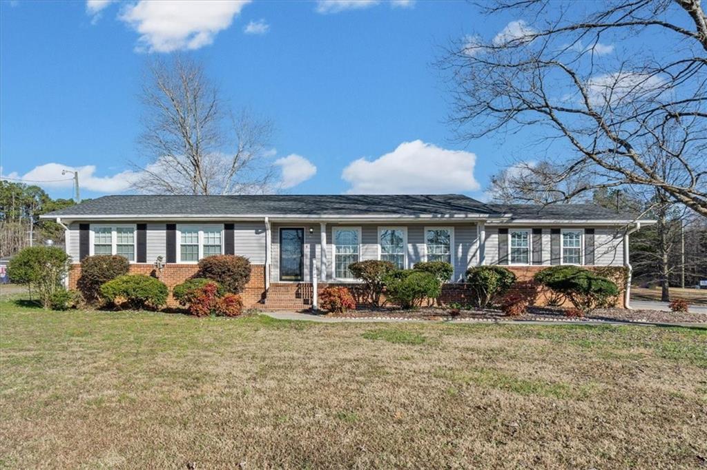 a front view of a house with sitting space and garden