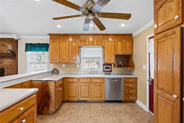 a kitchen with a sink window and cabinets
