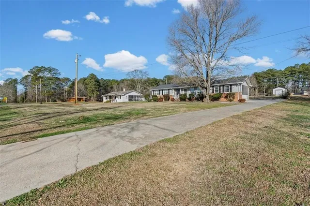a city view with tall buildings and a cars park side of a road