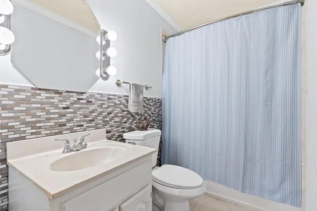 a bathroom with a sink a toilet and mirror