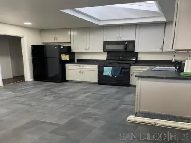 a kitchen with a refrigerator and a stove