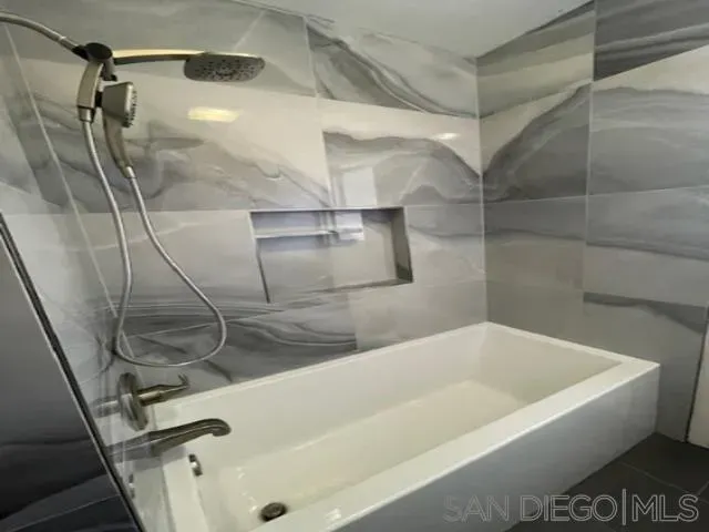 a bathroom with a bathtub and shower