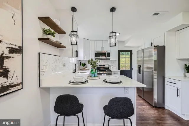 a view of kitchen with dining table and chairs