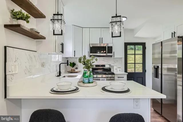 a kitchen with a sink a stove and chairs