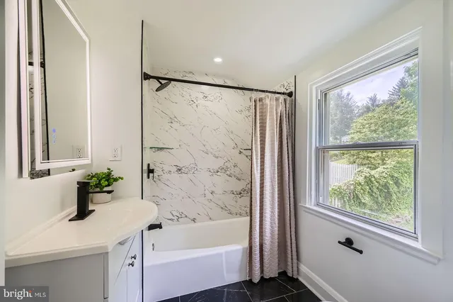 a bathroom with a bathtub and a sink