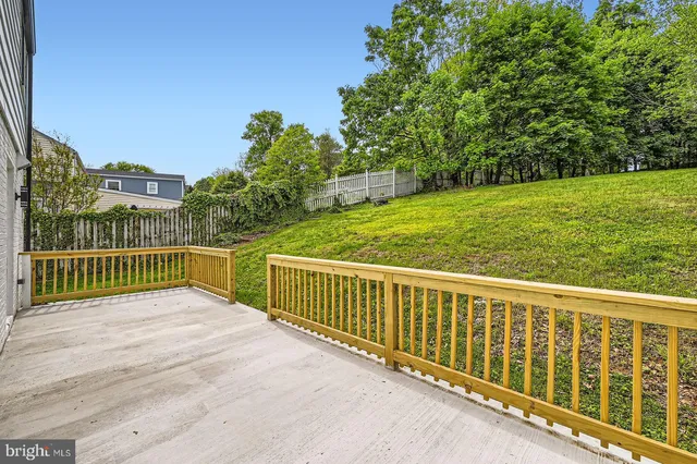 a view of a balcony with yard