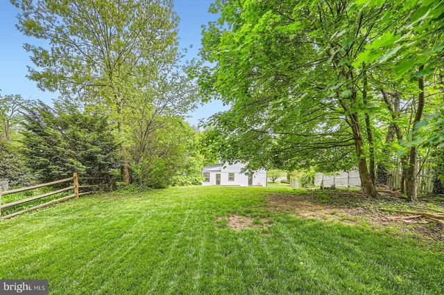 a view of green field with trees in the background