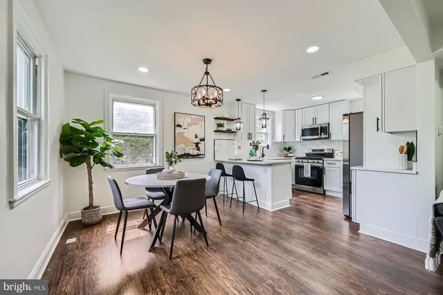 a view of kitchen with refrigerator and wooden floor