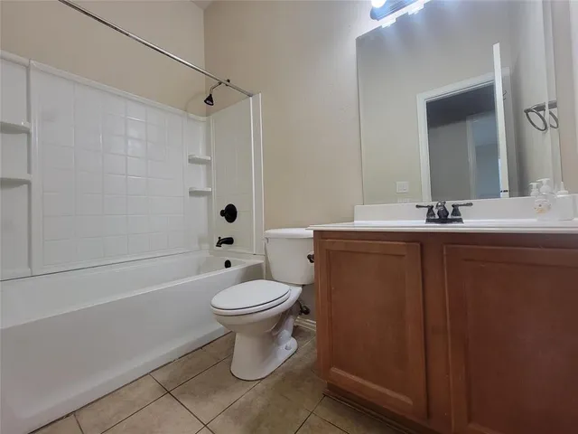 a bathroom with a sink a toilet a mirror and shower