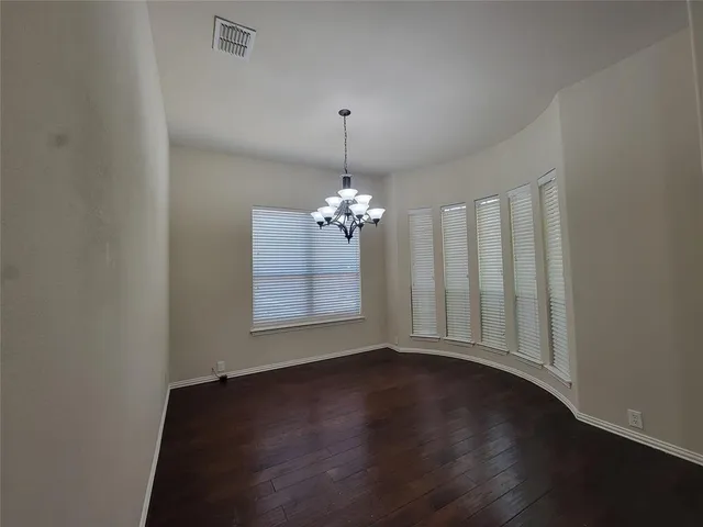 a view of wooden floor and a chandelier in a room
